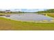 Panoramic view of the peaceful lake, with lush green grass in the foreground at 14559 Walcott Ave, Orlando, FL 32827