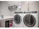 Convenient laundry room featuring front loading washer and dryer with ample storage and folding space at 14559 Walcott Ave, Orlando, FL 32827