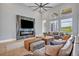 Open-concept living area featuring modern fireplace, large windows and comfortable furniture at 14559 Walcott Ave, Orlando, FL 32827