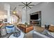Inviting living area with a fireplace, large TV, comfortable seating, and elegant decor at 14559 Walcott Ave, Orlando, FL 32827