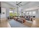 Spacious living room with high ceilings, large windows, modern furniture, and natural light at 14559 Walcott Ave, Orlando, FL 32827