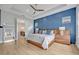 Beautiful main bedroom featuring a blue accent wall and en-suite bathroom access at 14559 Walcott Ave, Orlando, FL 32827