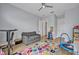 Spacious playroom featuring a colorful rug, cozy sofa, and various toys to inspire creativity and active play at 14559 Walcott Ave, Orlando, FL 32827