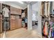 Spacious walk-in closet with custom shelving and drawers for optimal organization and a peek into the stylish bathroom at 14559 Walcott Ave, Orlando, FL 32827