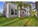 The spacious backyard features manicured grass, a palm tree, and well maintained exteriors at 15210 Chapter Way, Winter Garden, FL 34787