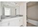 Well-lit bathroom with double sinks, a large mirror, and a shower-tub combination at 15210 Chapter Way, Winter Garden, FL 34787