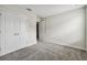 Comfortable carpeted bedroom with neutral walls and white trim and a double closet with sliding doors at 15210 Chapter Way, Winter Garden, FL 34787