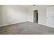 Spacious carpeted bedroom with neutral walls, white trim, and a view to the hallway at 15210 Chapter Way, Winter Garden, FL 34787