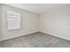 Carpeted bedroom featuring neutral walls and trim and a bright window with white blinds at 15210 Chapter Way, Winter Garden, FL 34787