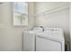 Convenient laundry room featuring a washer, dryer, and window at 15210 Chapter Way, Winter Garden, FL 34787