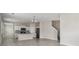 Open-concept living space features tile floors, a kitchen, and a staircase at 15210 Chapter Way, Winter Garden, FL 34787