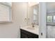 Bathroom vanity with dark cabinet, white countertop, and modern fixtures with a window at 1539 Wynell St, St Cloud, FL 34771