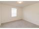 A bright bedroom with neutral carpeting and a large window at 1539 Wynell St, St Cloud, FL 34771