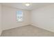 Carpeted bedroom with natural light from a large window at 1539 Wynell St, St Cloud, FL 34771