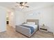 Comfortable bedroom featuring neutral decor, wood-look floors, ceiling fan and narrow horizontal window at 1539 Wynell St, St Cloud, FL 34771