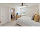 Comfortable bedroom with ensuite bath and ceiling fan, perfect for relaxation at 1539 Wynell St, St Cloud, FL 34771