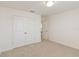Carpeted bedroom with a double door closet, open door, and neutral paint at 1539 Wynell St, St Cloud, FL 34771