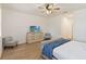 Bedroom with wood-look floors featuring a TV on a dresser and two upholstered chairs at 1539 Wynell St, St Cloud, FL 34771