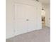 Bright bedroom featuring a large double-door closet and neutral carpeting at 1539 Wynell St, St Cloud, FL 34771