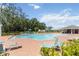 A beautiful community pool with lounge chairs and a covered pavilion on a sunny day at 1539 Wynell St, St Cloud, FL 34771