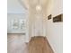Bright entryway featuring wood-look tile, a decorative chandelier, and an open view into the living room at 1539 Wynell St, St Cloud, FL 34771