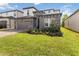 Beautiful two-story home with stone accents, a two-car garage and lush green lawn at 1539 Wynell St, St Cloud, FL 34771