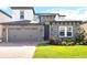 Charming two-story home featuring stone accents, a well-manicured lawn, and a brick driveway at 1539 Wynell St, St Cloud, FL 34771