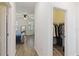 Hallway leading to bedroom and walk-in closet with clothes hanging on racks at 1539 Wynell St, St Cloud, FL 34771