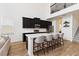 Modern kitchen boasts dark cabinetry, stainless steel appliances, and a quartz countertop island with seating at 1539 Wynell St, St Cloud, FL 34771