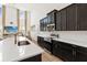 Kitchen featuring dark cabinetry, white countertops, and stainless steel appliances in a well-lit space at 1539 Wynell St, St Cloud, FL 34771