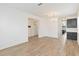 Bright living room with elegant chandelier and view into the kitchen featuring modern cabinets at 1539 Wynell St, St Cloud, FL 34771