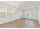 Bright, empty room with wood-look flooring and multiple windows at 1539 Wynell St, St Cloud, FL 34771