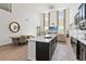 Spacious living area with tall windows, an open layout, and a sleek kitchen island at 1539 Wynell St, St Cloud, FL 34771