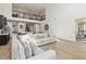 Open-concept living area with a loft overlooking, modern decor, and access to an outdoor patio at 1539 Wynell St, St Cloud, FL 34771
