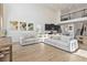 Bright living room with tall ceilings, a modern sofa, and an open view to the upstairs loft at 1539 Wynell St, St Cloud, FL 34771