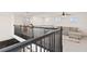 Upstairs living area featuring black metal railing, gray sofa and computer desk at 1539 Wynell St, St Cloud, FL 34771