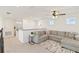 Spacious loft featuring a large gray sectional sofa, neutral carpet, ceiling fan and natural light at 1539 Wynell St, St Cloud, FL 34771