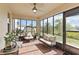 Enclosed patio with brick floor, ceiling fan, and outdoor seating at 1539 Wynell St, St Cloud, FL 34771