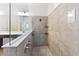 Spacious walk-in shower with glass partition, tile surround, and brushed nickel fixtures at 1539 Wynell St, St Cloud, FL 34771