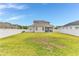 Spacious backyard with lush green grass and a white privacy fence at 16078 St Clair St, Clermont, FL 34714