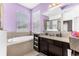 This is a primary bathroom with a soaking tub and neutral colored walls at 16078 St Clair St, Clermont, FL 34714