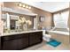 Bathroom featuring a tub, toilet, and dual vanity at 16078 St Clair St, Clermont, FL 34714