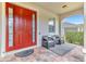 Inviting front porch featuring a decorative rug and two chairs for relaxing at 16078 St Clair St, Clermont, FL 34714