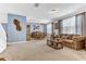 Inviting living room featuring comfortable seating, large windows, and dining area at 16078 St Clair St, Clermont, FL 34714