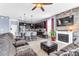 Open-concept living room with a fireplace, kitchen island, and comfortable seating at 16078 St Clair St, Clermont, FL 34714