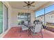 Covered patio with a dining table, chairs, ceiling fan, and a grill at 16078 St Clair St, Clermont, FL 34714