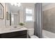 Clean bathroom featuring modern vanity, tiled shower, and ample lighting at 16354 Grey Pine Dr, Winter Garden, FL 34787