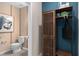 Stylish half bathroom features modern fixtures, unique wall decor, and built-in shelving for storage at 16354 Grey Pine Dr, Winter Garden, FL 34787