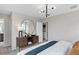 Bright bedroom with a large mirror, stylish decor, and open access to the laundry room at 16354 Grey Pine Dr, Winter Garden, FL 34787
