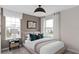 Serene bedroom featuring large windows, neutral color palette, and comfortable furnishings at 16354 Grey Pine Dr, Winter Garden, FL 34787